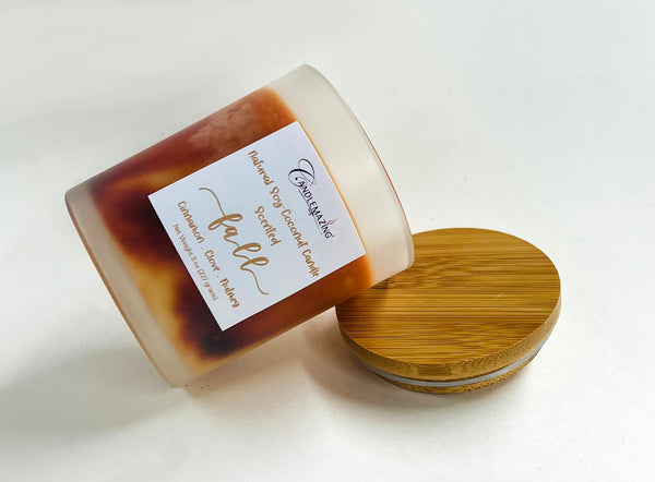 Beautiful Blend of Coconut and Soy wax make this lovely Fall scented candle with notes of cinnamon, clove, nutmeg and more. Marbled with orange color, complete with bamboo lid in a sturdy frosted glass jar. Side view
