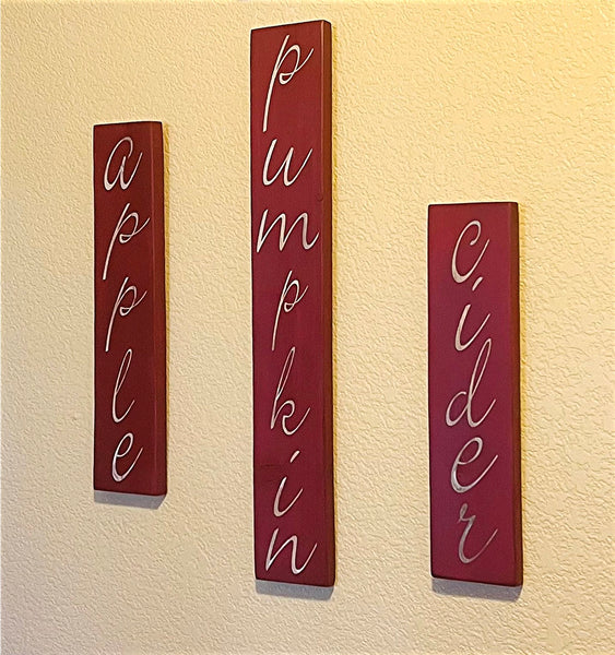 Creative Wood Sign with Fall words - Apple, Pumpkin, Cider. 3 Pieces with sawtooth hangers on back. Ready to arrange .